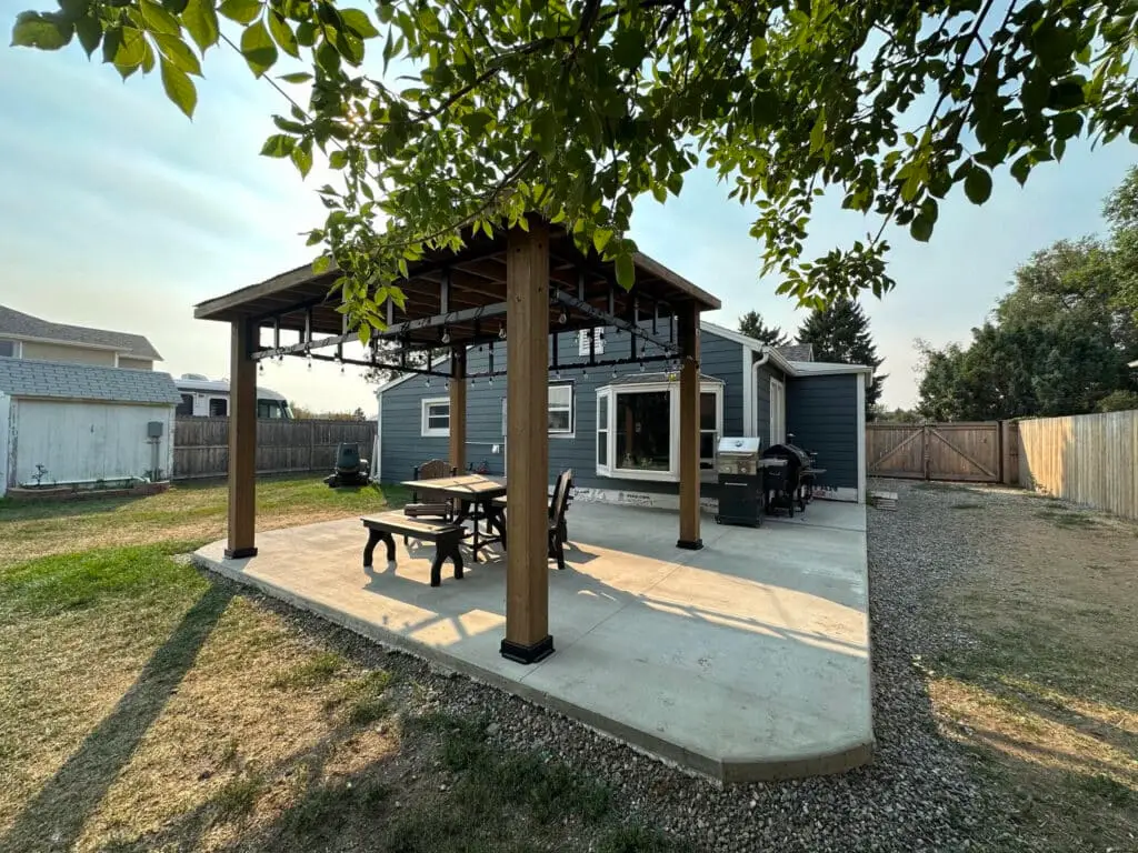 blue house with patio and gazebo